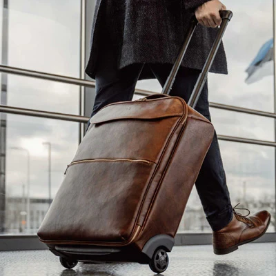 A person walking with luggage in an airport.