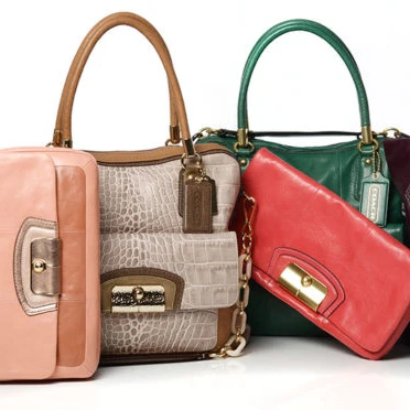 A group of different colored purses sitting on top of each other.