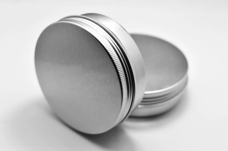 A close up of a silver container on top of a table.